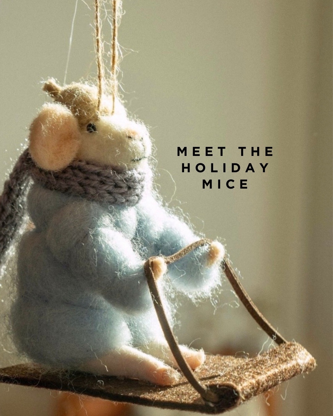 Closeup of a felt mouse ornament in a puffer jacket on a sled. Image says 