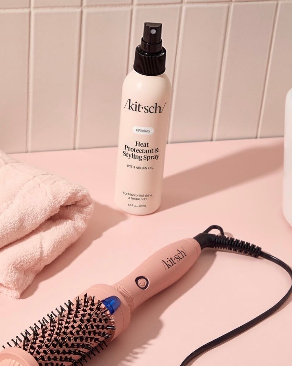 Kitsch brand hair products. Heat spray and heated round brush in pink on pink counter