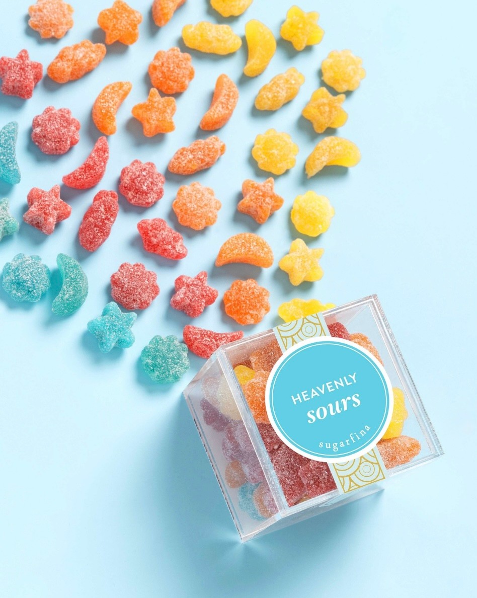 Sugarfina Heavenly Sours colour-coated on a light blue background